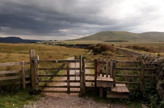 Wooden fence and gate in a field