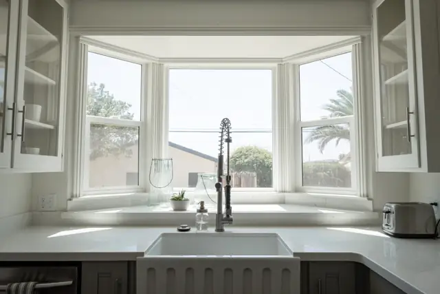 Bright kitchen with farmhouse sink under a window
